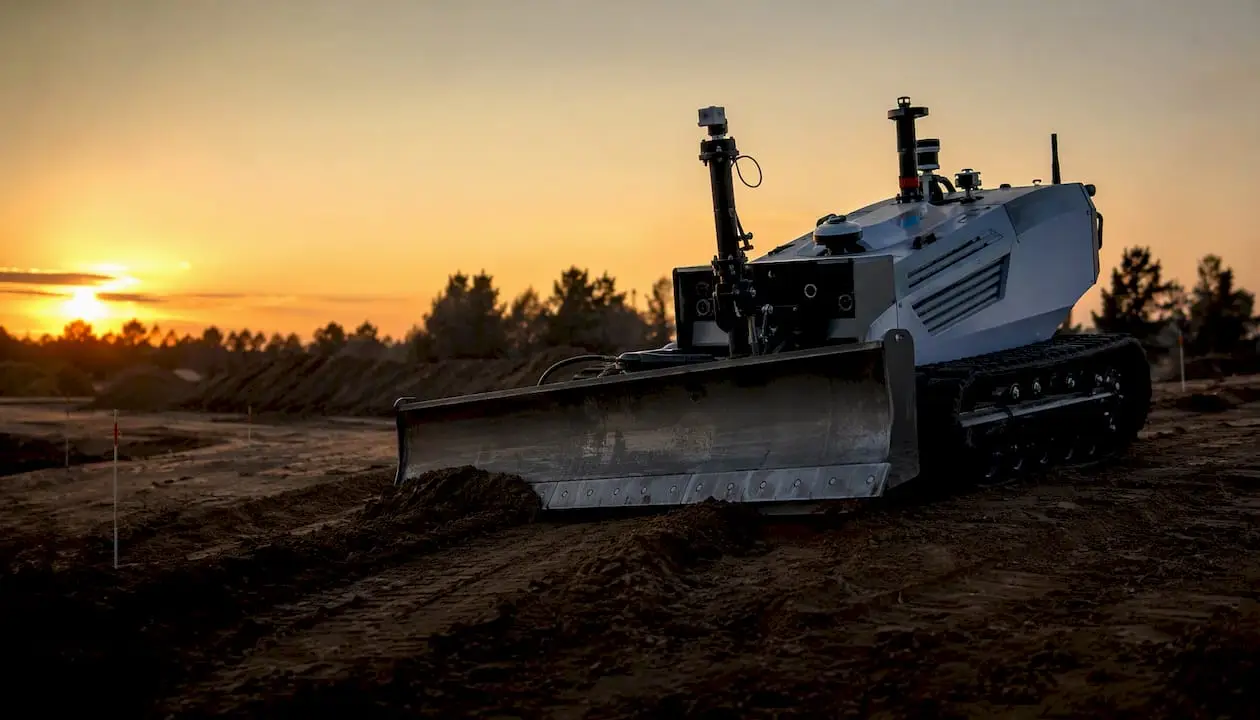 Autonomous earthmoving machine grading soil