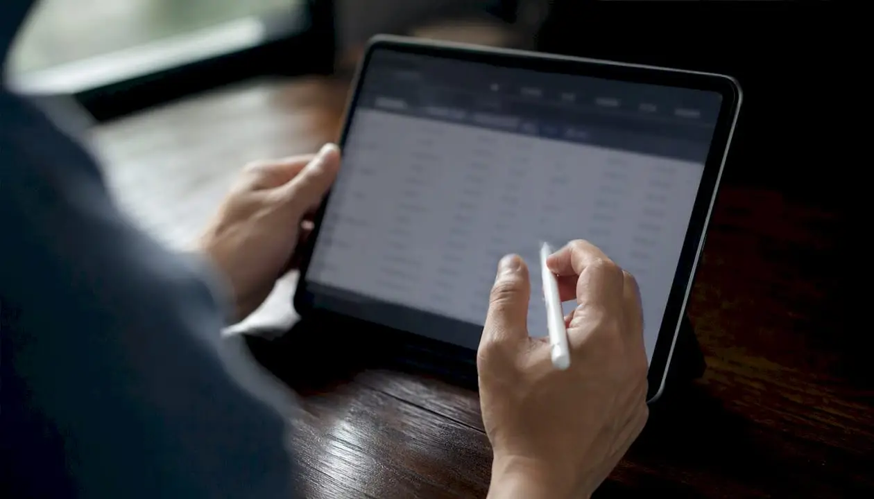 Hands updating data inventory on tablet