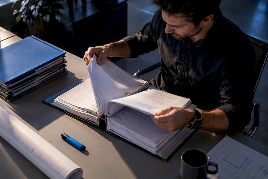 Engineer reviewing construction specification binder